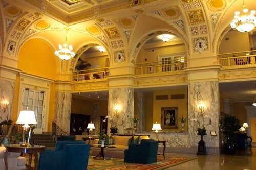 selective focus photography of burger patty, mayonnaise, and French fries served on platter
