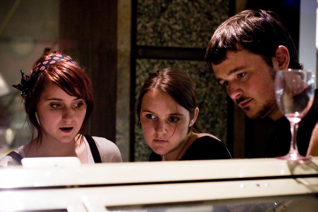 black kitchen appliance on kitchen island with pendant lights